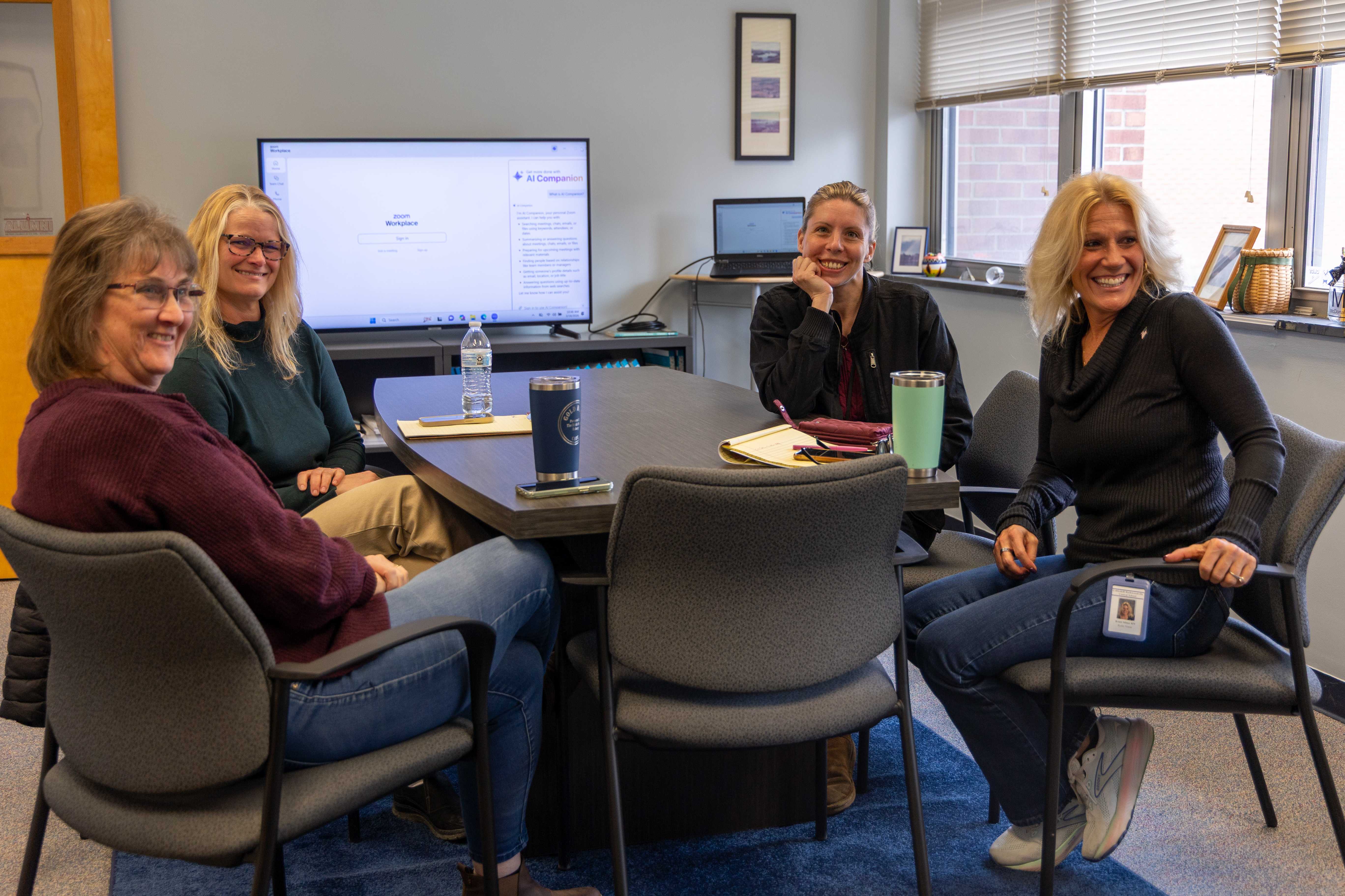 A group of school nurses smile together